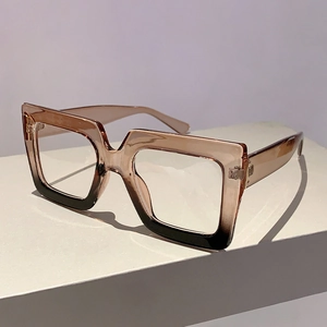 Detail of square oversized frames with tea and black gradient finish on display stand