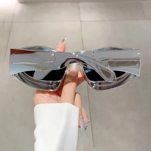 Close-up of Y2K futuristic sunglasses with silver chrome finish and wide wrap frame
