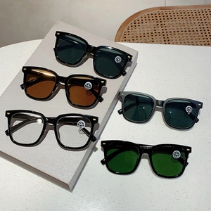 Nahaufnahme der quadratischen Oversized-Sonnenbrille mit Kristallgläsern und Golddekor
