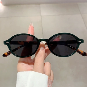 Retro oval sunglasses with dark green frame and tortoiseshell temples for women