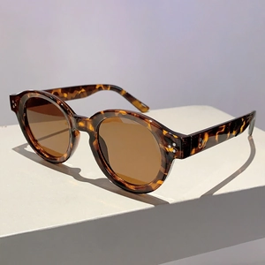 Detailed macro view of retro tortoiseshell frames with stylish three-dot metal rivets