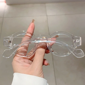 Detailed close-up of transparent round frame glasses showing the silver metal hinges