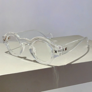 Close-up of transparent round frame glasses featuring silver square rivet decorations