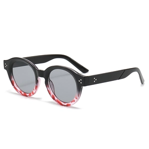 Retro round tortoise shell sunglasses with black contrast frame and metal rivets