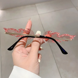 Close-up of pink flame shaped rimless sunglasses with sparkling rhinestone embellishments