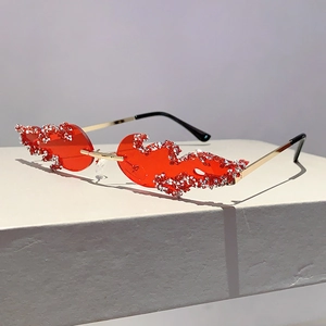 Detail of red flame-shaped rimless sunglasses with sparkling silver rhinestones