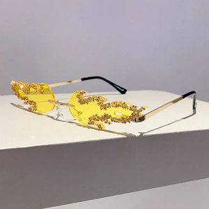 Detail of yellow flame-shaped sunglasses with sparkling rhinestones and gold metal temples