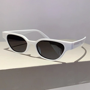 Close-up of retro white thick-framed sunglasses with dark lenses on geometric base