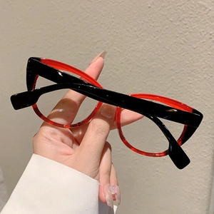 Macro view of vintage round two-tone glasses featuring black and dark red inner frames