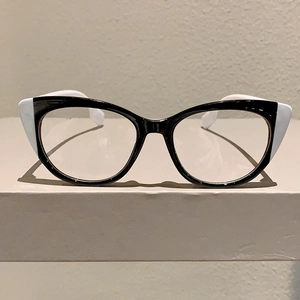 Close-up of retro cat-eye glasses with bold black and white contrast frame design