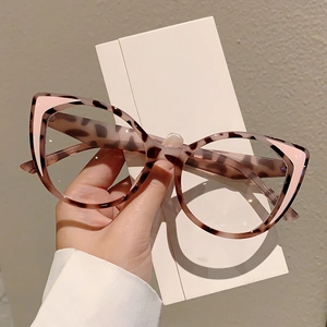 Detail of leopard print cat-eye glasses frame with pink triangle accents