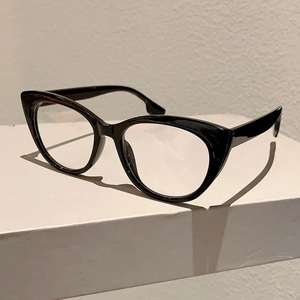 Detail view of glossy black cat-eye glasses frame with stylish stepped temple design