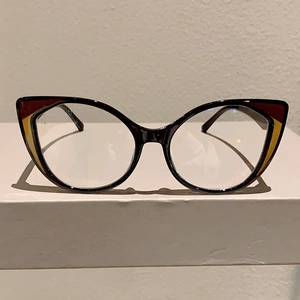 Close-up of cat-eye glasses frame with leopard print details and geometric patterns
