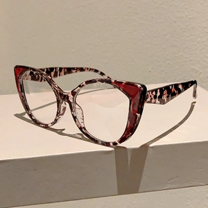 Detail of stylish cat-eye glasses frame featuring bold leopard print and tortoise texture