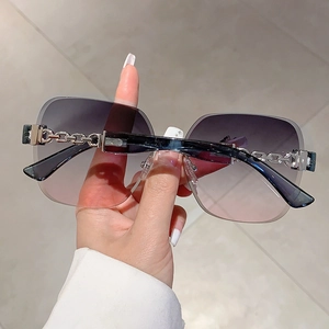 Detail of rimless square sunglasses with metallic silver chain temple design