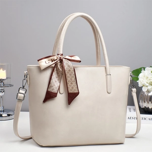 Elegant cream PU leather tote bag with decorative silk scarf and detachable shoulder strap