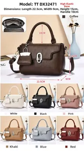 Detail of lychee pattern leather handbag with metal lock clasp and mini charm accessory