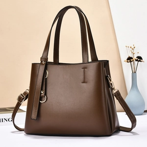 Deep coffee brown leather tote bag with metal ring charm and adjustable shoulder strap