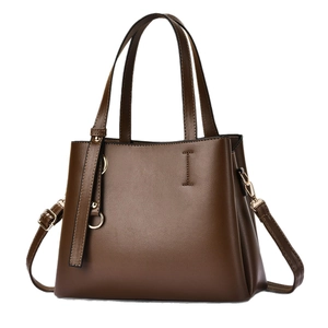 Classic dark brown tote bag with leather texture, dual handles and golden hardware