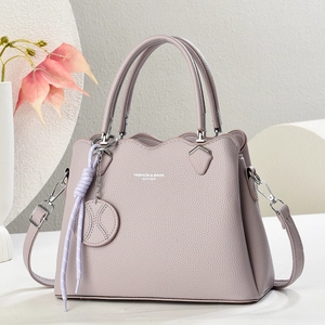 Lavender lychee pattern leather handbag with wavy top handle and detachable strap