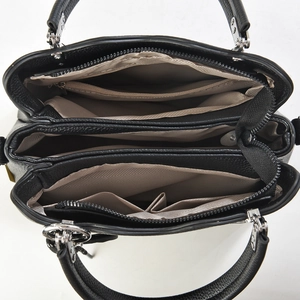 Top view of black leather handbag interior showing multiple compartments and tan lining