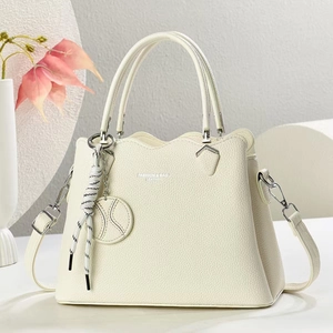 Detail of cream lychee leather handbag with dual handles and fashion logo print