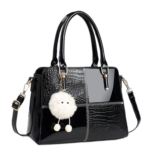 Elegant black patent leather handbag with crocodile pattern and golden chain strap