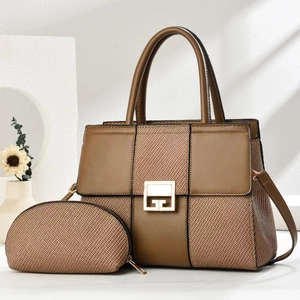 Detail of minimalist two-piece tote bag with woven texture and gold G buckle hardware