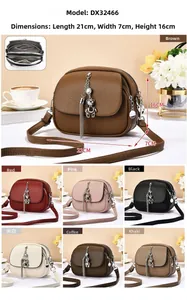 Detail view of multi-layer zipper crossbody bag in lychee texture with bear charm