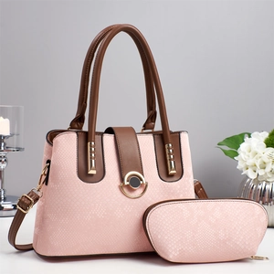 Detail view of pink snakeskin pattern tote bag with gold lock and matching pouch