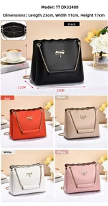 Detail view of scalloped edge handbag with bow metal clasp and interior dimensions