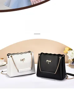 Close-up of wavy top edge with golden rhinestone butterfly on PU leather handbags