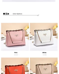 Detail view of scalloped edge shoulder bags with metal bow accent in various colors