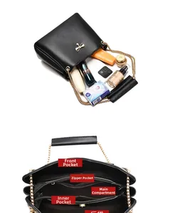 Detail of black bucket bag showing spacious interior compartments and gold chain strap