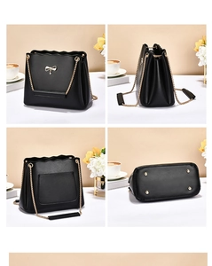 Detail view of black handbag with gold bow charm and metal chain strap in four angles