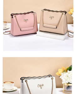 Detail of elegant shoulder bags featuring wavy edges and pearl metal bow decorations
