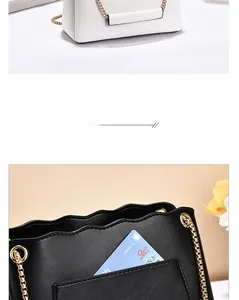 Detail of lychee pattern leather and gold metal chain strap on chic crossbody bags