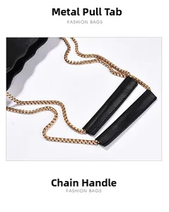 Detail of gold circular chain handle with premium black leather stitching on fashion handbag