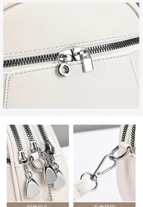 Detail of premium lychee texture leather with silver heart-shaped zipper and metal clasps