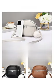 Detailed view of women's crossbody bags with triple zipper pockets and plush ball charm