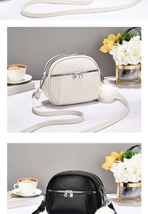 Close-up of litchi texture faux leather crossbody bag with three zip compartments