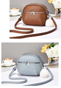 Detailed view of multi-compartment leather crossbody bags in brown and light blue