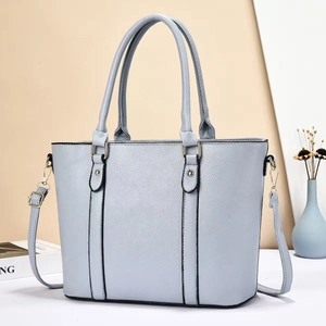 Detail of grey-blue pebble leather tote bag with gold hardware and removable shoulder strap