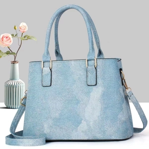 Chic light blue denim texture tote bag with golden hardware and adjustable strap