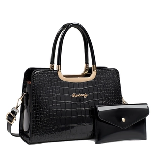 Glossy black crocodile pattern handbag set with top handle and matching envelope clutch