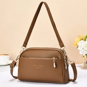 Brown litchi grain PU leather crossbody bag with three zipper compartments for women