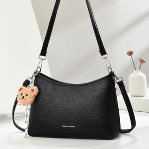 Minimalist black pebble leather hobo shoulder bag with bear charm and silver zipper