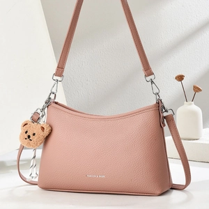 Pink hobo shoulder bag with litchi texture and cute brown plush bear charm