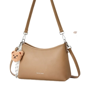 Brown litchi leather hobo bag with teddy bear charm and fashion logo print