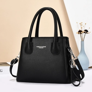 Classic black lychee texture handbag with elegant silver hardware and shoulder strap